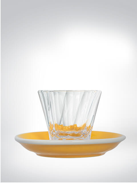 Clear glass on a yellow saucer