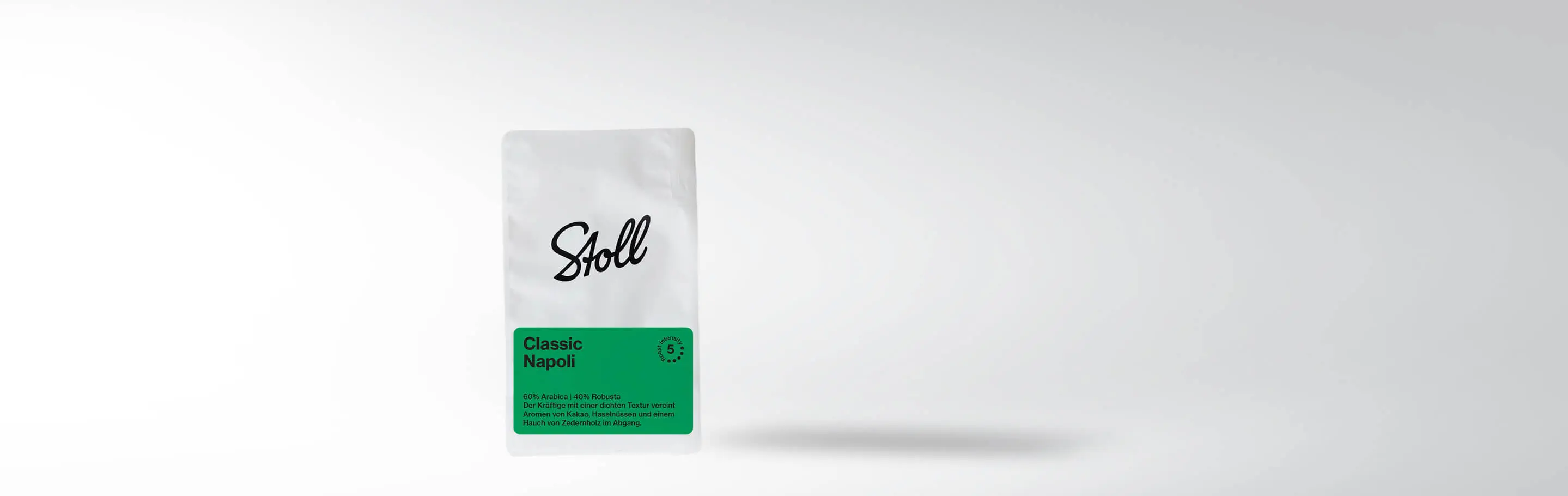 Packaging of Stoll Classic Napoli Coffee, 60% Arabica, 40% Robusta, with notes of cocoa, hazelnuts, and cedarwood